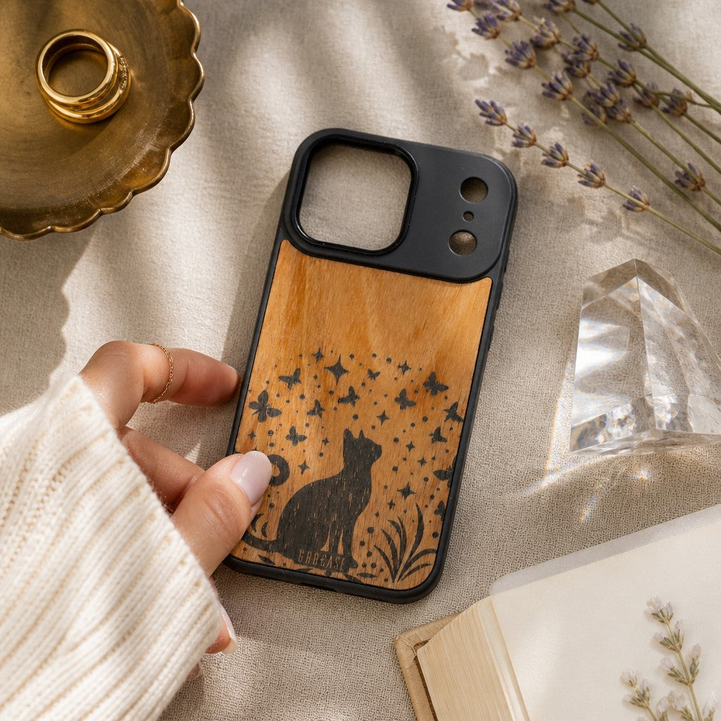 Hand-finished wood phone case featuring a celestial cat silhouette looking up at butterflies and twinkling stars.