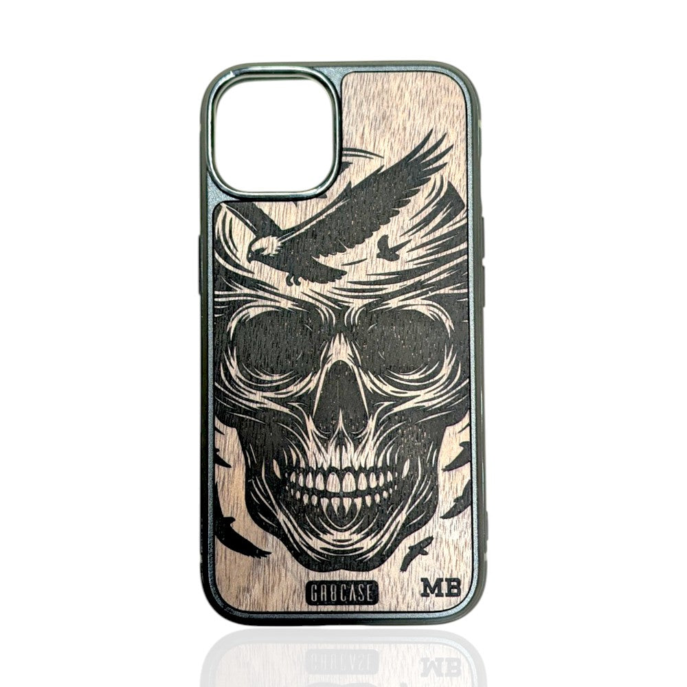 Detailed human skull with swooping eagles laser-engraved on a hand-finished premium wood phone case.