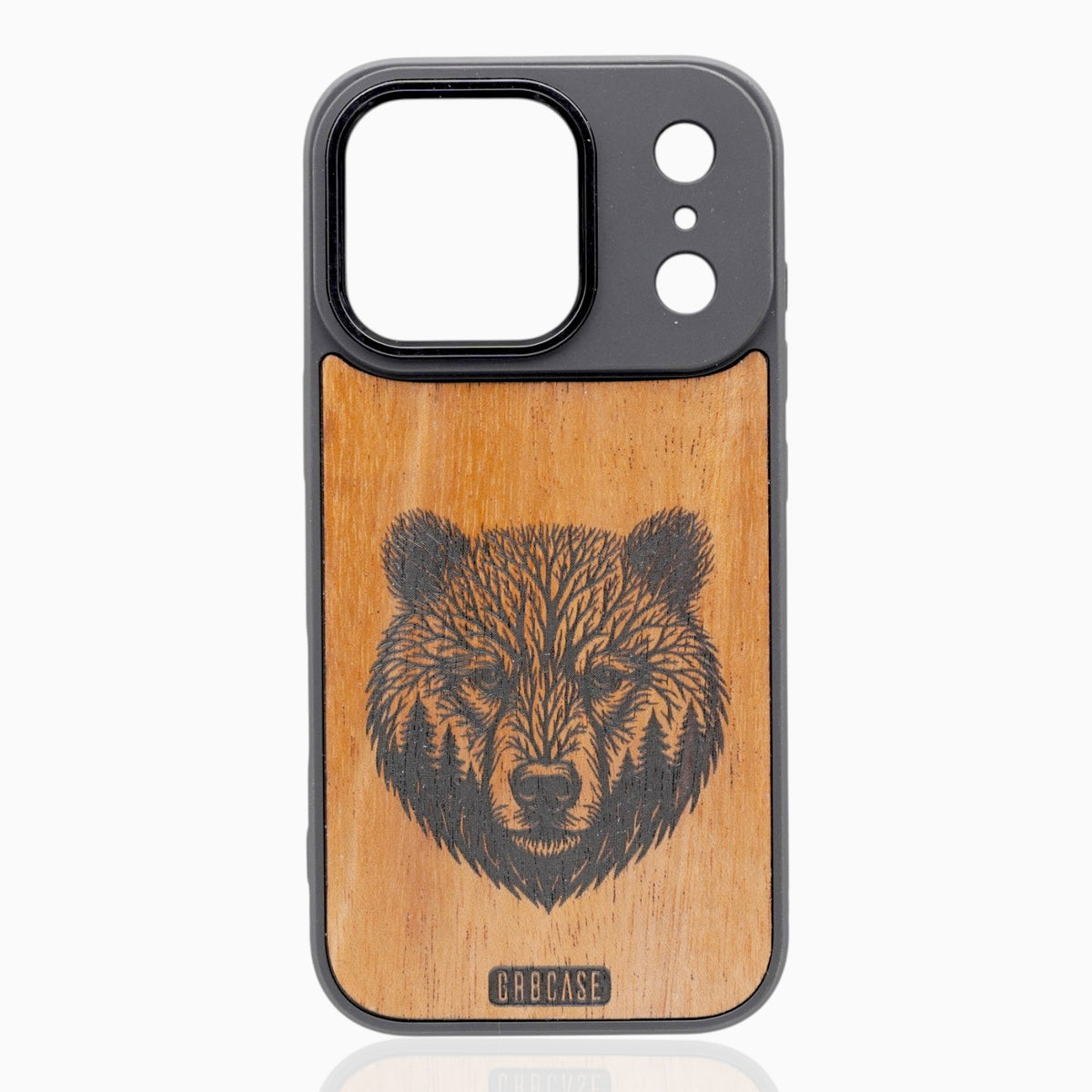 Hand-finished natural wood phone case featuring an intricate laser engraving of a grizzly bear head formed by tree branches and forest pines.
