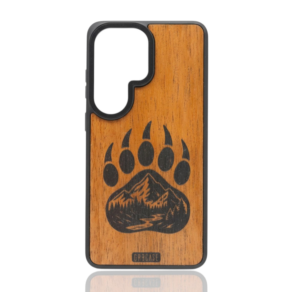 Hand-finished wood phone case featuring a bear paw print with a laser-etched mountain and forest landscape inside.